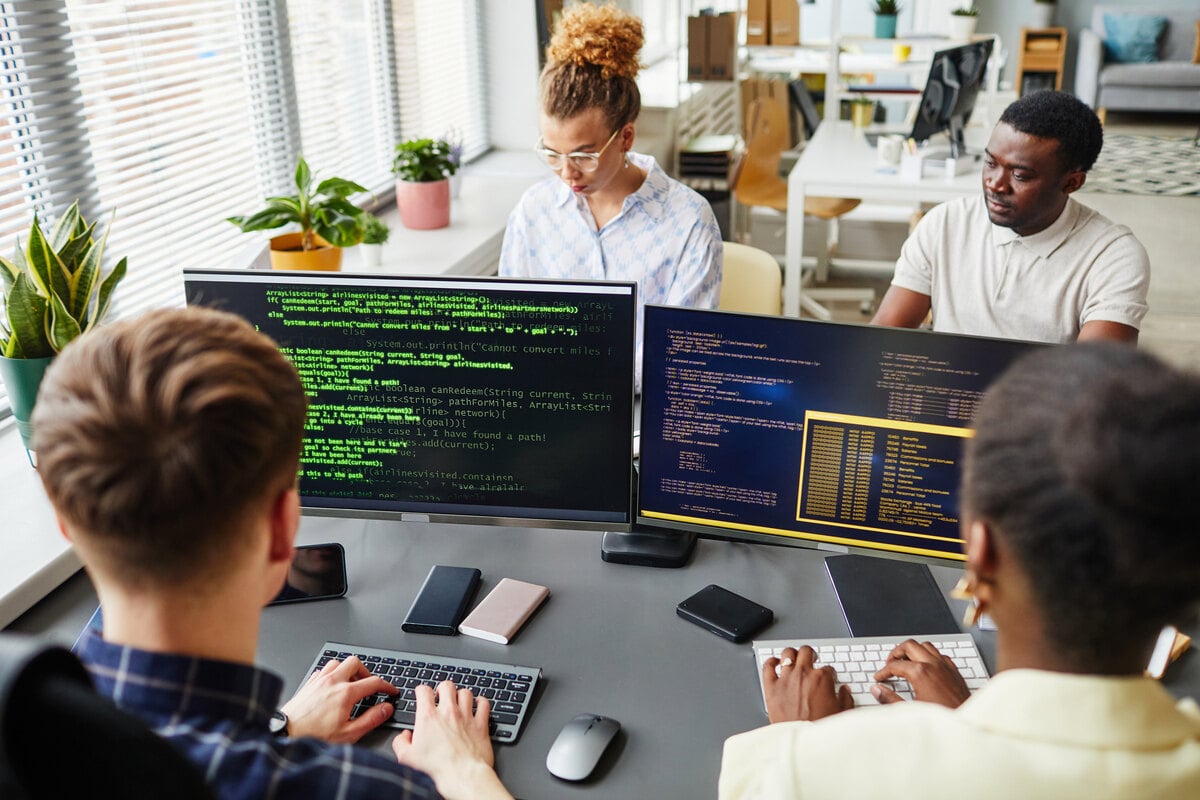 Nearshore software development engineers working on code