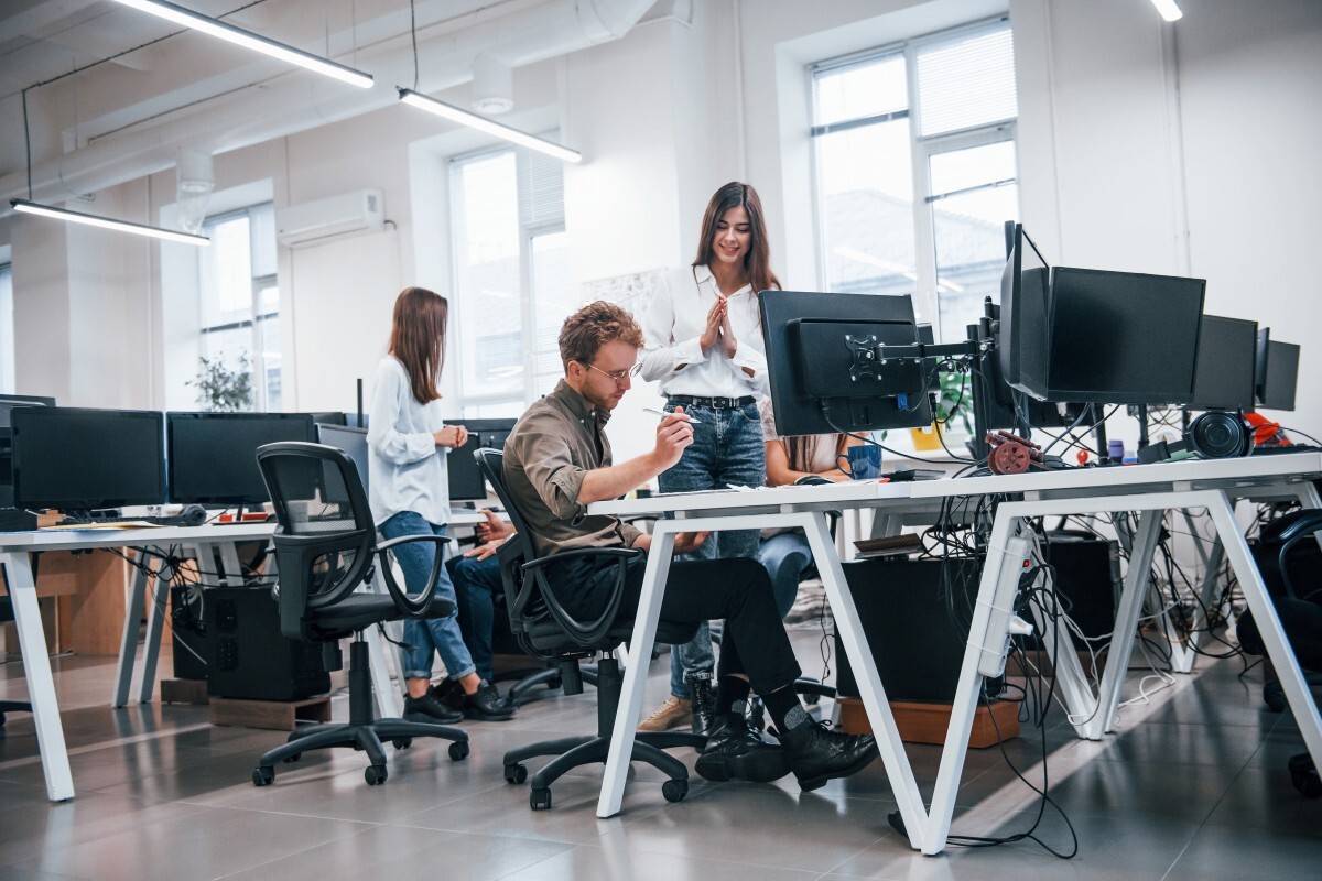 Software developer working with multiple screens in a technology environment